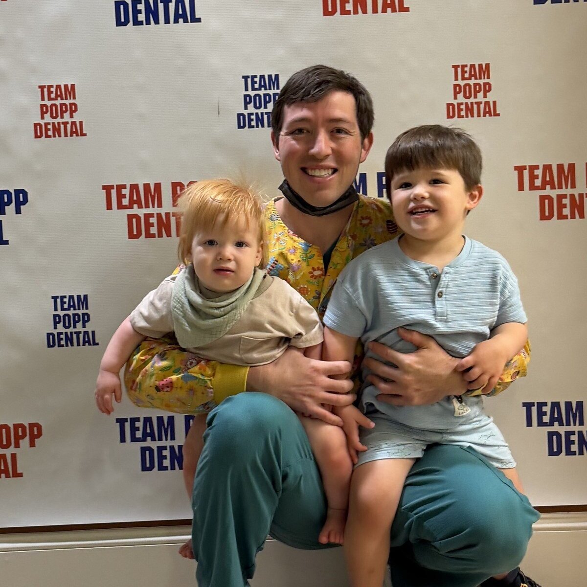Dr. Colton Popp with his two sons at Team Popp Pediatric Dentistry